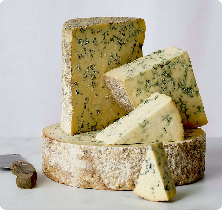 Wedges of Stilton cheese on a wooden board